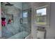 Stylish shower area featuring gray marble tile, built-in niche, and a glass enclosure at 540 Benton Rd, Covington, GA 30014