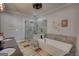 Relaxing bathroom featuring a glass-enclosed shower and a sleek, modern soaking tub at 540 Benton Rd, Covington, GA 30014