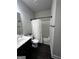 Well-lit bathroom featuring a combination tub and shower with sleek fixtures and vinyl floors at 64 N Village Cir, Rydal, GA 30171
