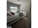 Cozy bedroom with a well-lit window, complemented by a dresser and tasteful decor at 64 N Village Cir, Rydal, GA 30171