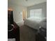 Inviting bedroom boasts natural light, carpet, and convenient access to an en-suite bathroom at 64 N Village Cir, Rydal, GA 30171