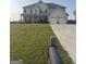 Two-story home boasts an attached two-car garage and a well-manicured lawn at 64 N Village Cir, Rydal, GA 30171