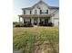 Charming home featuring a welcoming covered porch, enhanced by manicured landscaping at 64 N Village Cir, Rydal, GA 30171