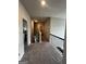 Upstairs hallway with carpet and railing overlooking the stairway at 64 N Village Cir, Rydal, GA 30171