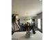 Inviting open-concept living room with a cozy fireplace and staircase at 64 N Village Cir, Rydal, GA 30171