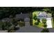 An aerial view showcasing the home's landscaping, driveway, and proximity to neighboring houses at 3953 Willow Fields Ct, Loganville, GA 30052