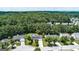 An aerial view of the property showcasing its well-manicured lawn, complemented by mature trees, nestled within a friendly neighborhood at 3953 Willow Fields Ct, Loganville, GA 30052