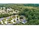 Panoramic aerial shot featuring a quiet suburban community surrounded by lush green trees and winding roads at 3953 Willow Fields Ct, Loganville, GA 30052