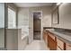 Well-lit bathroom featuring a tub, vanity with solid surface countertop, and neutral color palette at 3953 Willow Fields Ct, Loganville, GA 30052