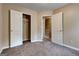 Bedroom features neutral walls, carpet, closet, and a doorway to a hallway with stairs at 3953 Willow Fields Ct, Loganville, GA 30052