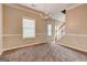 Open dining room with chandelier lighting, wainscoting and crown molding at 3953 Willow Fields Ct, Loganville, GA 30052