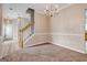 Open dining room with chandelier lighting, access to the main entry, and view of the staircase at 3953 Willow Fields Ct, Loganville, GA 30052