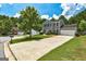 Two-story home with gray siding, black shutters, well-kept lawn and long driveway at 3953 Willow Fields Ct, Loganville, GA 30052
