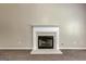 Close up of the fireplace with a white mantle and gray tile hearth on neutral carpet at 3953 Willow Fields Ct, Loganville, GA 30052