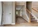 Inviting home foyer features wood floors, staircase, and views into the adjacent living space at 3953 Willow Fields Ct, Loganville, GA 30052