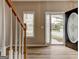 Welcoming foyer with wood floors, staircase, and view of the front door at 3953 Willow Fields Ct, Loganville, GA 30052
