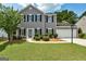 Charming two-story home featuring grey siding, black shutters, landscaped lawn, and attached garage at 3953 Willow Fields Ct, Loganville, GA 30052