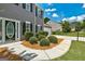 Close-up of front door and shrubbery with lawn next to driveway and gray siding at 3953 Willow Fields Ct, Loganville, GA 30052