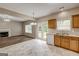 Bright kitchen features tile floor, white appliances, wood cabinets and view of the living room and fireplace at 3953 Willow Fields Ct, Loganville, GA 30052