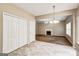 Eat-in kitchen features tile floor and white appliances, with a view of the carpeted living room and fireplace at 3953 Willow Fields Ct, Loganville, GA 30052