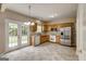 Well-lit kitchen featuring wooden cabinets, stainless steel appliances, tile floor, and french doors at 3953 Willow Fields Ct, Loganville, GA 30052