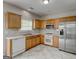 Well-lit kitchen featuring modern appliances, light wood cabinets, and a stainless steel refrigerator at 3953 Willow Fields Ct, Loganville, GA 30052