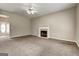 Spacious living room with neutral carpet, fireplace, ceiling fan, and front door at 3953 Willow Fields Ct, Loganville, GA 30052