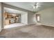 Open-concept living room features a combined kitchen, staircase, and neutral-colored walls at 3953 Willow Fields Ct, Loganville, GA 30052