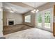 Open-concept living room and kitchen area with tile floor, fireplace and french doors to the backyard at 3953 Willow Fields Ct, Loganville, GA 30052