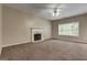 Spacious living room with fireplace and large window, filled with natural light at 3953 Willow Fields Ct, Loganville, GA 30052