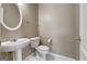 Classic powder room featuring a pedestal sink, round mirror, and neutral wall color at 3953 Willow Fields Ct, Loganville, GA 30052