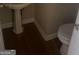 Cozy half-bathroom with a pedestal sink and wood-look flooring at 4887 Winterview Ln, Douglasville, GA 30135
