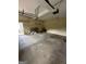 Uncluttered garage with concrete flooring and a pull-down ladder at 4887 Winterview Ln, Douglasville, GA 30135