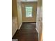 Practical laundry room equipped with cabinetry, a window, and dark wood-look flooring at 4887 Winterview Ln, Douglasville, GA 30135