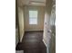 Practical laundry room equipped with cabinetry, a window, and dark wood-look flooring at 4887 Winterview Ln, Douglasville, GA 30135