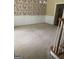 A living room with wallpaper, a wainscot, and staircase at 4887 Winterview Ln, Douglasville, GA 30135