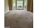 Bright living room featuring a large bay window and neutral carpet at 4887 Winterview Ln, Douglasville, GA 30135