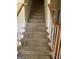 Staircase with carpeted steps and white and wood railing at 4887 Winterview Ln, Douglasville, GA 30135