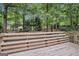 Spacious wooden deck with railings and a great view of the tree-filled backyard at 161 Bradford Pl, Stockbridge, GA 30281