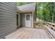 The back porch features wood floors, a back door and view of the wooded yard at 161 Bradford Pl, Stockbridge, GA 30281
