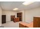 Unfinished basement with light walls, carpet, wooden shelving and fluorescent ceiling lights at 161 Bradford Pl, Stockbridge, GA 30281