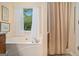 Bright bathroom with a garden tub, window and a separate shower featuring support bars at 161 Bradford Pl, Stockbridge, GA 30281