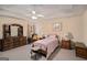 Bedroom boasts a tray ceiling, ceiling fan, with a comfy bed and classic wood furniture at 161 Bradford Pl, Stockbridge, GA 30281