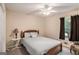 Bedroom with a ceiling fan, side table with lamp, and a comfortable bed at 161 Bradford Pl, Stockbridge, GA 30281