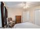 Bright bedroom featuring a comfortable chair, a closet, and a wooden dresser at 161 Bradford Pl, Stockbridge, GA 30281