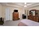 Spacious bedroom with a ceiling fan, tray ceiling, and classic wood furniture at 161 Bradford Pl, Stockbridge, GA 30281