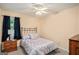 Cozy bedroom with a ceiling fan, a side table with a lamp, and closet at 161 Bradford Pl, Stockbridge, GA 30281