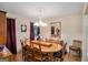 Elegant dining room with a large wood table, chandelier, and ample seating for gatherings at 161 Bradford Pl, Stockbridge, GA 30281