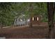 Charming home featuring a mix of brick and siding, nestled among mature trees and lush foliage at 161 Bradford Pl, Stockbridge, GA 30281