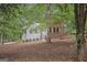 Charming home featuring a mix of brick and siding, nestled among mature trees and lush foliage at 161 Bradford Pl, Stockbridge, GA 30281